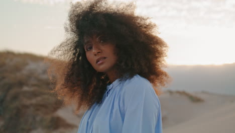 Portrait-african-american-woman-with-lush-curly-hair-at-desert-gloomy-summer.