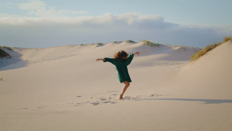 Modern-dancer-performing-desert-dunes-summer-day-in-distance.-Girl-dancing.