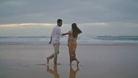 Happy-sweethearts-walking-evening-beach-outdoors.-Hispanic-couple-running-nature