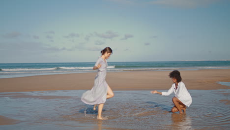 Carefree-girl-having-fun-at-ocean-beach-vertical-video.-Cheerful-woman-playing
