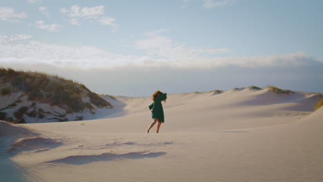 Girl-dancing-sand-dunes-at-summer-evening.-Woman-performing-sensually-movements.