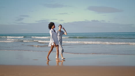 Lgbt-couple-go-ocean-coast-vertical-shot.-Carefree-friends-enjoy-conversation