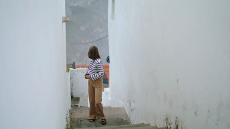 Traveler-walk-narrow-street-stairs-in-trip-vertical.-Beautiful-girl-explore-town