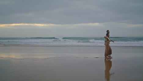 Loving-couple-hugging-evening-seashore-at-summer.-Spouses-honeymoon-vertical