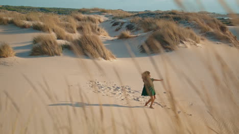 Girl-graceful-dance-sand-desert-summer-windy-evening.-Woman-performing-at-dunes.