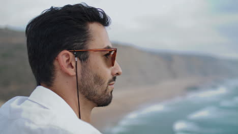 Sunglasses-man-watching-marine-horizon-closeup.-Thoughtful-tourist-enjoying-sea