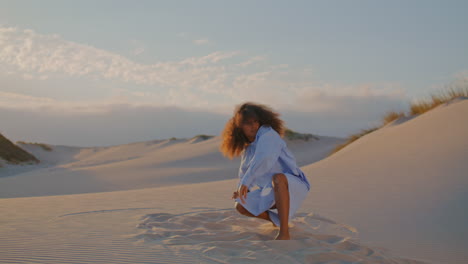 Passionate-girl-dancer-performing-freestyle-in-desert-at-sunset.-Woman-dancing.