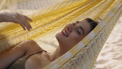 Summer-girl-enjoying-hammock-vertically-closeup.-Happy-woman-dreaming-rest-beach