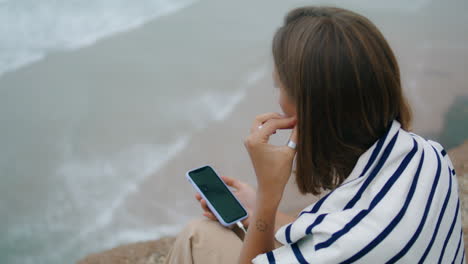 Beach-girl-listen-music-at-seashore-closeup.-Thinking-teenager-plug-in-earphones