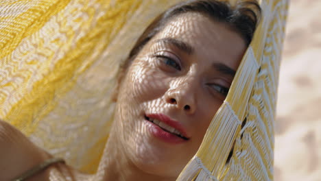 Calm-girl-daydreaming-hammock-in-sunlight-closeup.-Pretty-woman-enjoying-summer