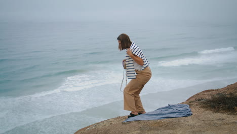Woman-rest-ocean-picnic-on-summer-weekend-vertical.-Carefree-girl-leaving-beach