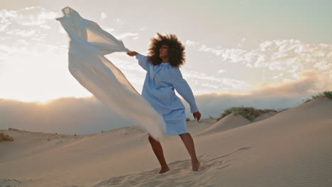 Girl-dancer-waving-fluttering-cloth-performing-contemporary-dance-in-desert.