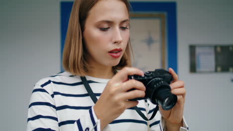 Closeup-hands-taking-analog-camera-vertically.-Focused-girl-shooting-pictures