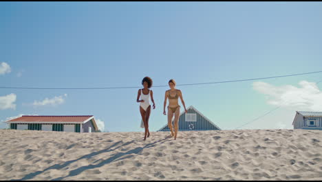 Lgbt-couple-running-beach-in-bikini.-Happy-girls-spending-summer-at-ocean-shore