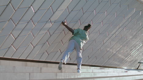 Creative-man-dancing-stadium-alone.-Black-guy-doing-contemporary-dance-moves