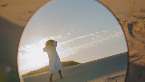 Girl-artist-dancing-sunset-sky-reflecting-in-mirror.-Woman-performing-at-desert.