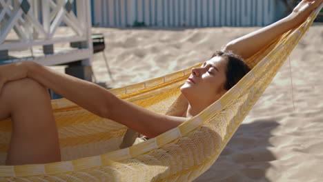 Happy-girl-lying-hammock-closeup.-Attractive-smiling-woman-enjoying-sunlight