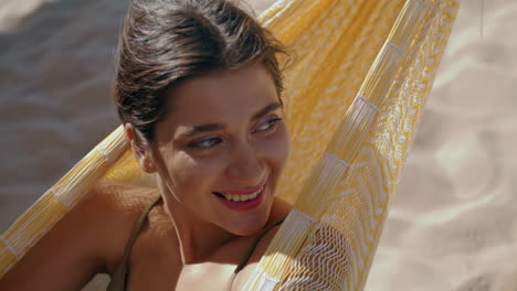 Woman-chilling-hammock-beach-alone-portrait.-Smiling-beautiful-girl-closing-eyes