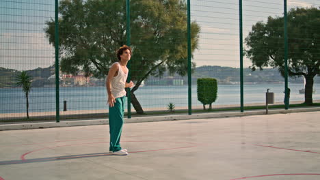 Basketball-player-throwing-ball-stadium.-Man-training-at-playground-vertical