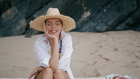 Girl-sitting-blanket-shore-in-straw-hat-close-up.-Woman-relaxing-beach-vertical