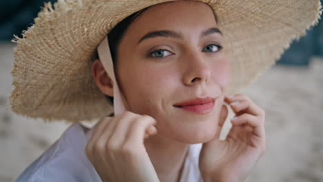 Portrait-carefree-girl-straw-hat-looking-camera-with-serene-smile.-Woman-posing