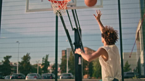 Teenager-throwing-ball-basket-back-view.-Modern-sportsman-playing-urban-game