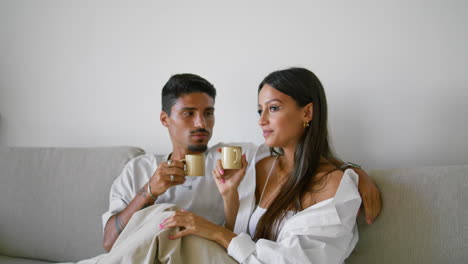 Romantic-couple-watching-movie-at-home-closeup.-Loving-family-enjoying-coffee