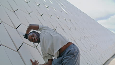 Dreadlocks-dancer-training-at-urban-architecture.-African-american-man-dancing