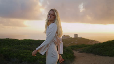 Blonde-tourist-posing-at-castle-valley.-Traveling-lady-relaxing-sunset-evening