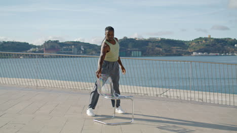 Flexible-performer-dancing-chair-embankment-vertical-video.-Dancer-choreography