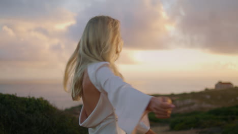 Relaxed-woman-enjoying-sunset-portrait.-Flying-hair-girl-turning-around-posing