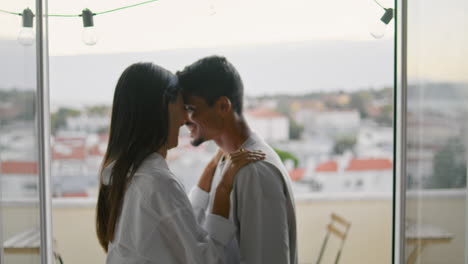Cute-newlyweds-dancing-home-closeup.-Couple-celebrating-at-sea-panorama-hotel