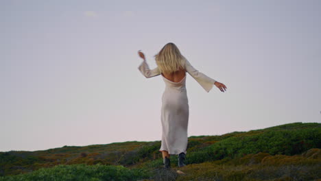 Sensual-woman-spinning-tower-landscape.-Carefree-girl-enjoying-lighthouse-nature