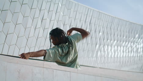 Hip-hop-man-dancing-street-vertical-closeup.-Trendy-guy-rehearsing-choreography