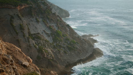 Foamy-ocean-cliff-landscape-vertical-aerial-view.-Deep-sea-washing-rocky-shore