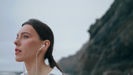 Portrait-beautiful-woman-headphones-listening-music-on-beach.-Girl-enjoy-songs