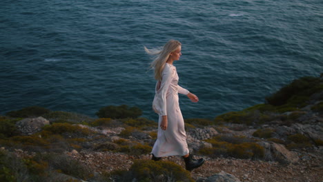Thoughtful-woman-walk-ocean-cliff-vertical.-Dreaming-girl-stepping-marine-hill