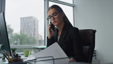 Beautiful-businesswoman-making-call-in-business-center.-Focused-assistant-work