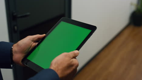 Manager-hands-holding-tablet-walking-office-closeup.-Chroma-key-digital-device