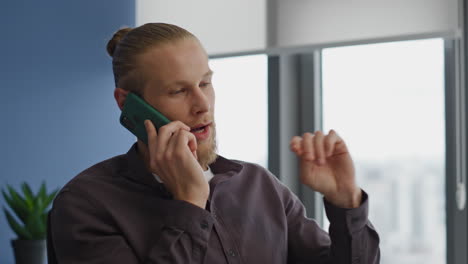 Serious-manager-talking-phone-office-interior-portrait.-Man-calling-smartphone