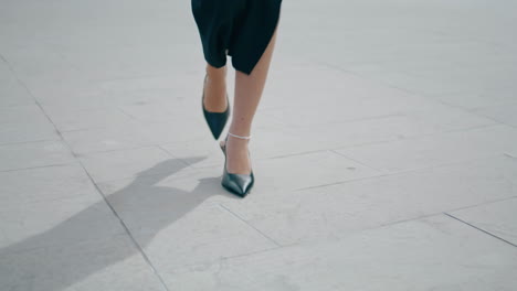 Woman-legs-walking-road-close-up.-Unknown-girl-in-heels-stepping-street-vertical