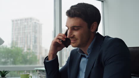 Confident-businessman-speaking-mobile-phone-closeup.-Smiling-manager-discussing