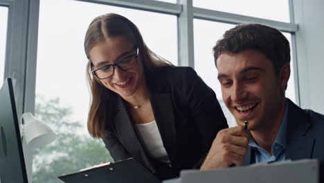Financial-managers-analysing-data-in-computer-portrait.-Smiling-team-working