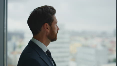 Thoughtful-businessman-standing-window-watching-cityscape-closeup.-Company-owner
