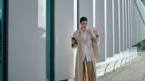 Woman-enjoy-video-conversation-by-smartphone-outdoors.-Girl-videochat-vertical