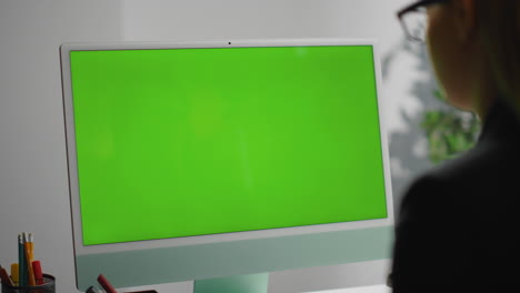 Closeup-office-green-desktop-computer.-Freelancer-surfing-web-checking-report