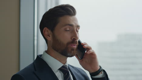 Manager-have-telephone-conversation-with-partners-at-panoramic-window-close-up