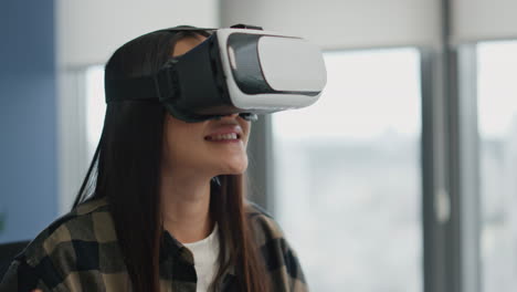 Happy-woman-watching-virtual-reality-at-office.-Excited-girl-touching-metaverse