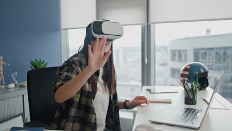 Happy-gamer-watching-virtual-reality-at-workplace.-Woman-future-technologies