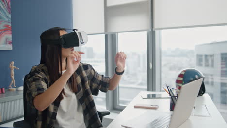 Headset-woman-examining-VR-at-city-view-flat.-Creative-game-designer-working